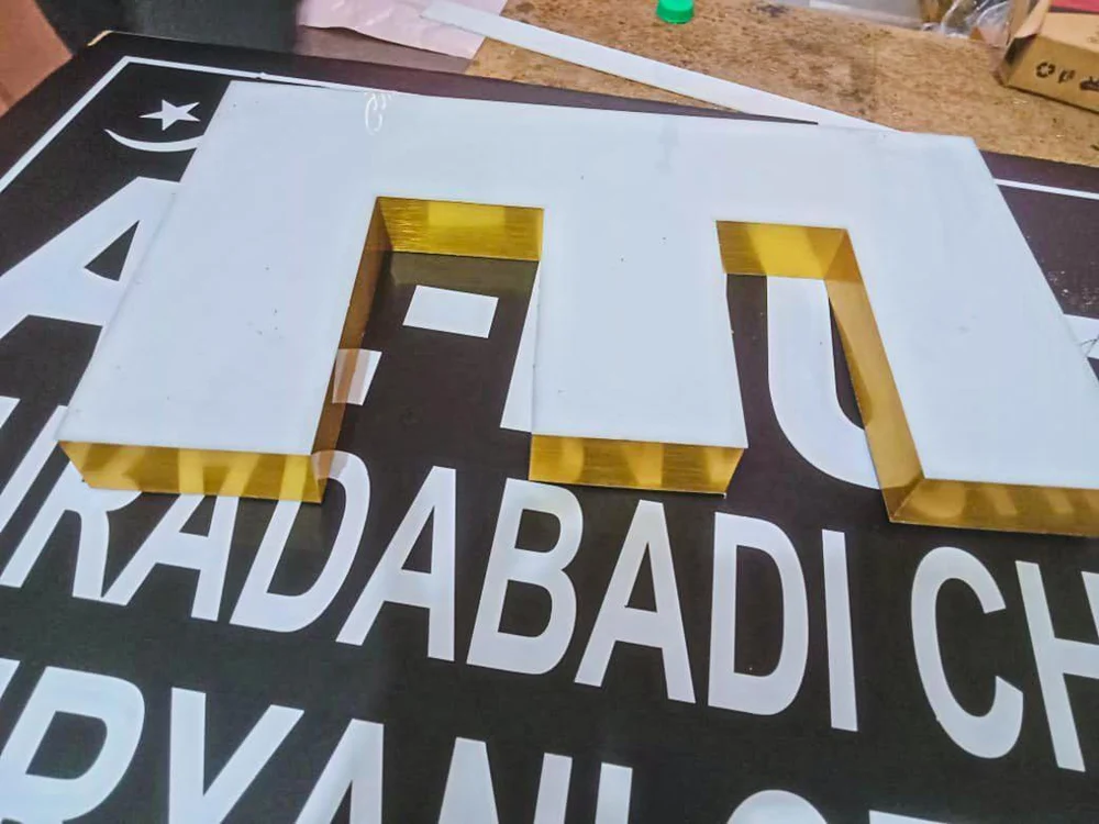 Gold finish channel letter fabrication close-up